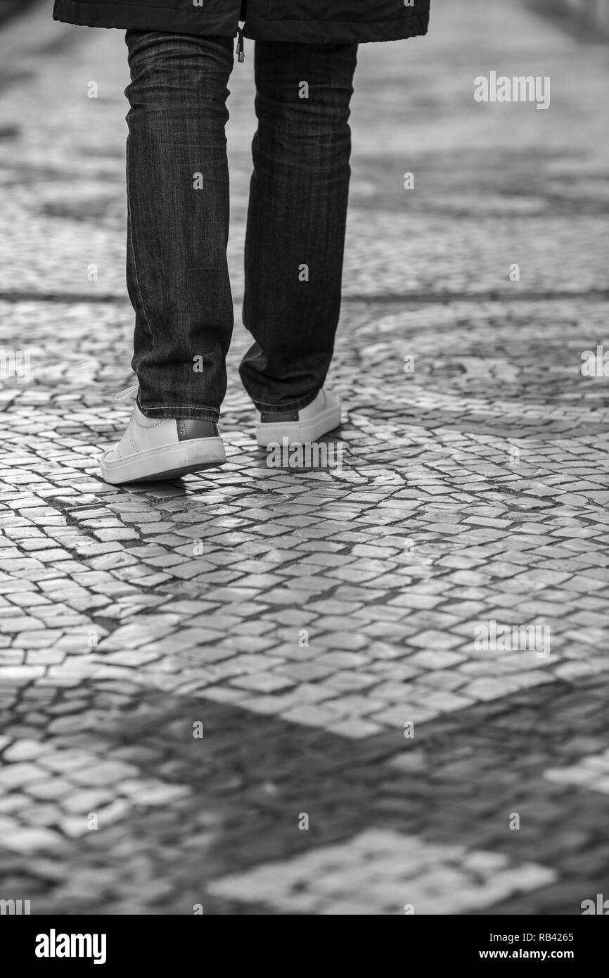 Black and white photo of human legs on the pavement, Lisbon, Portugal Stock Photo