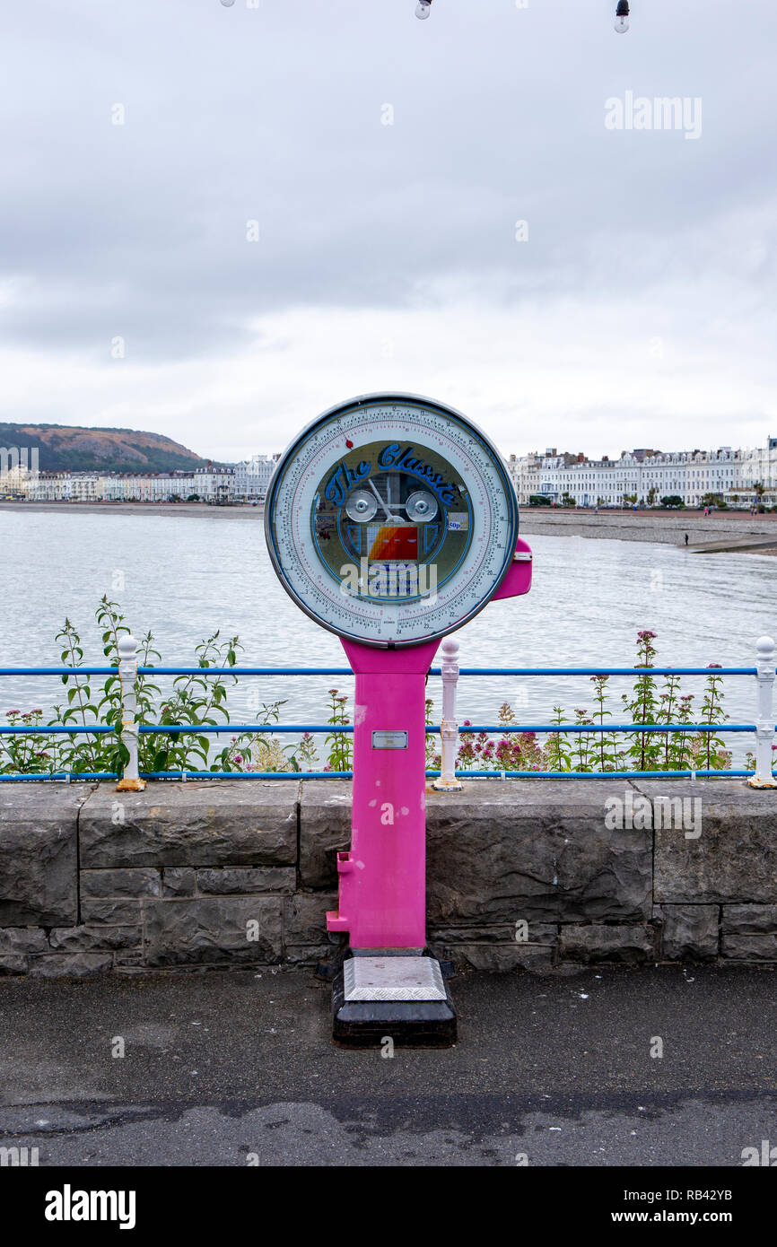 Old fashioned classic weighing machine on the pier in Llandudno Wales UK Stock Photo