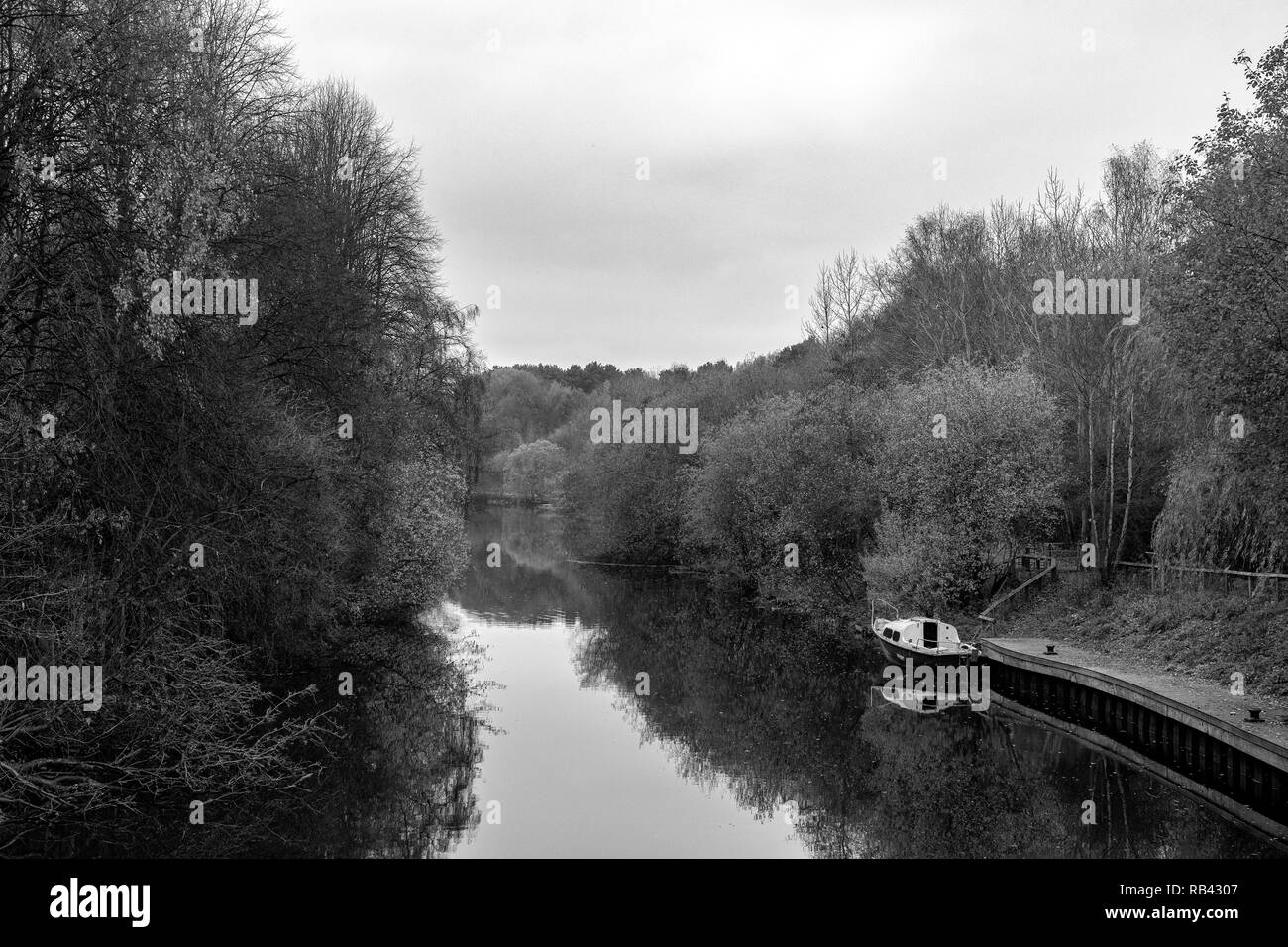 Abandoned boat in black & white on the river Weaver in Winsford Cheshire UK Stock Photo