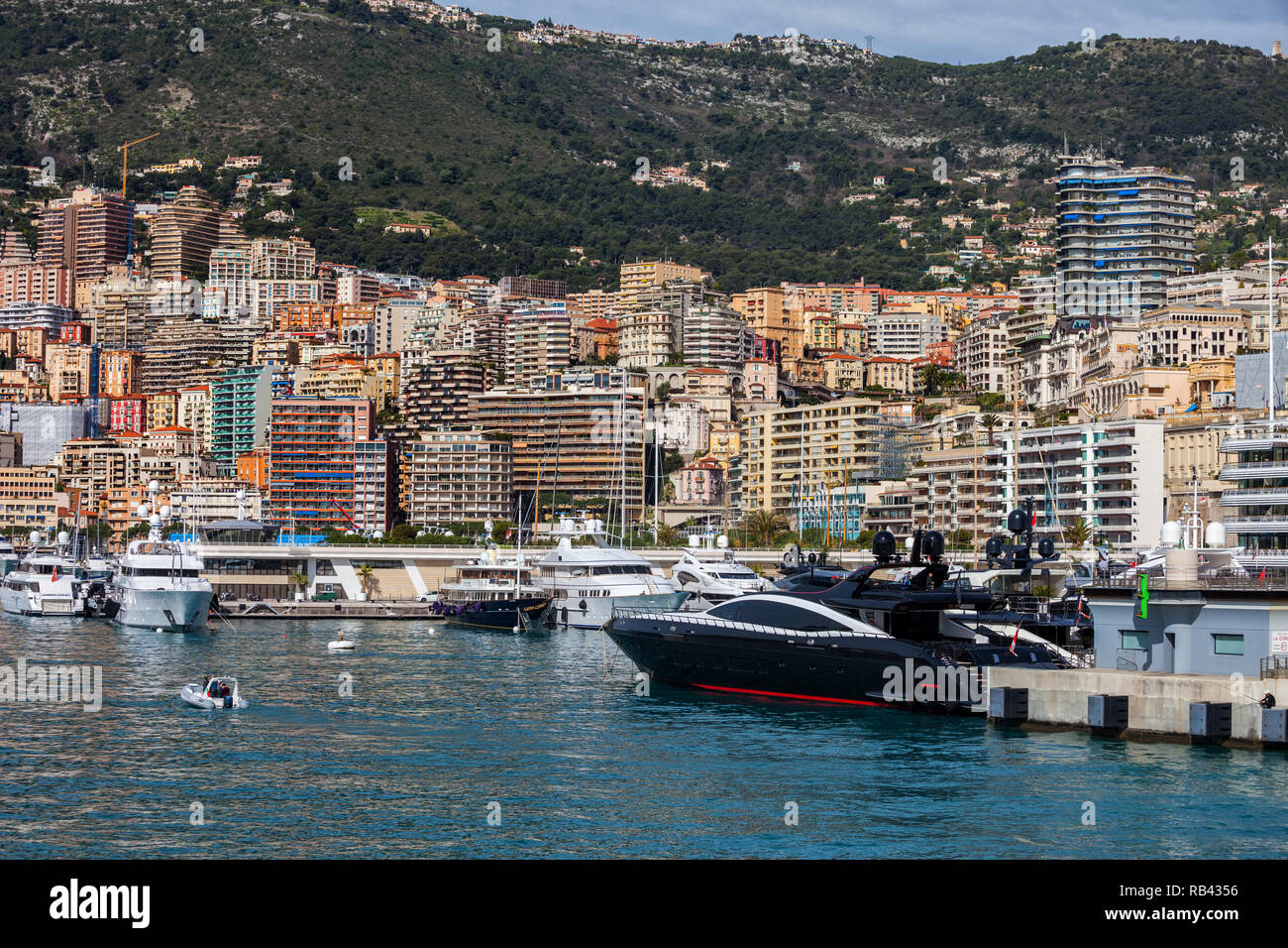 Monaco principality from Port Hercule, apartment buildings, block of flats, houses on steep coastal mountain slope Stock Photo