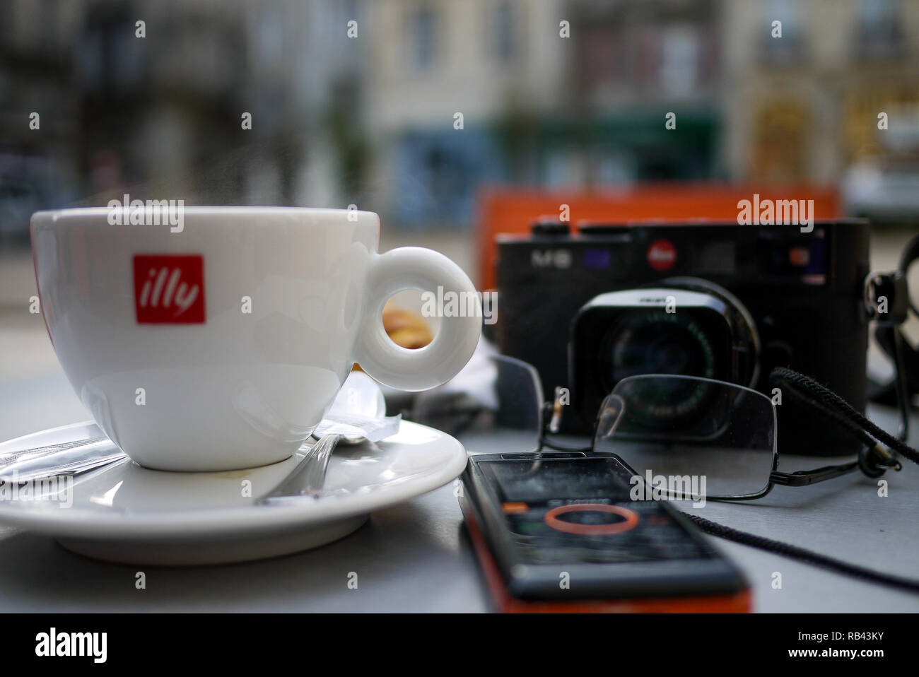 Camera, cup of coffee and mobile phone, a  photo-reporter's equipment, Bordeaux, Gironde, France Stock Photo