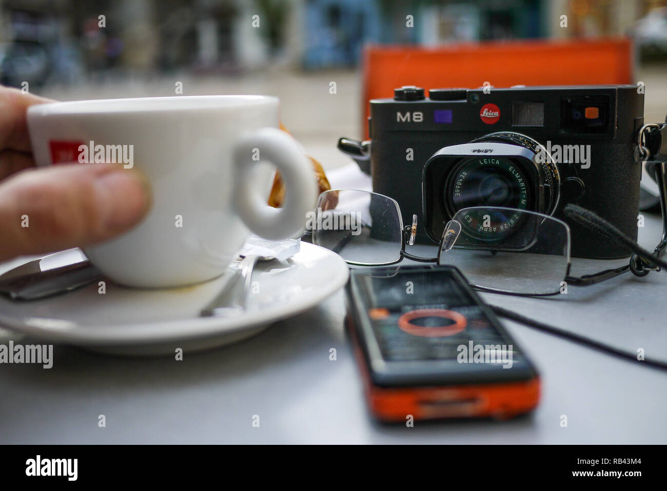 Camera, cup of coffee and mobile phone, a  photo-reporter's equipment, Bordeaux, Gironde, France Stock Photo