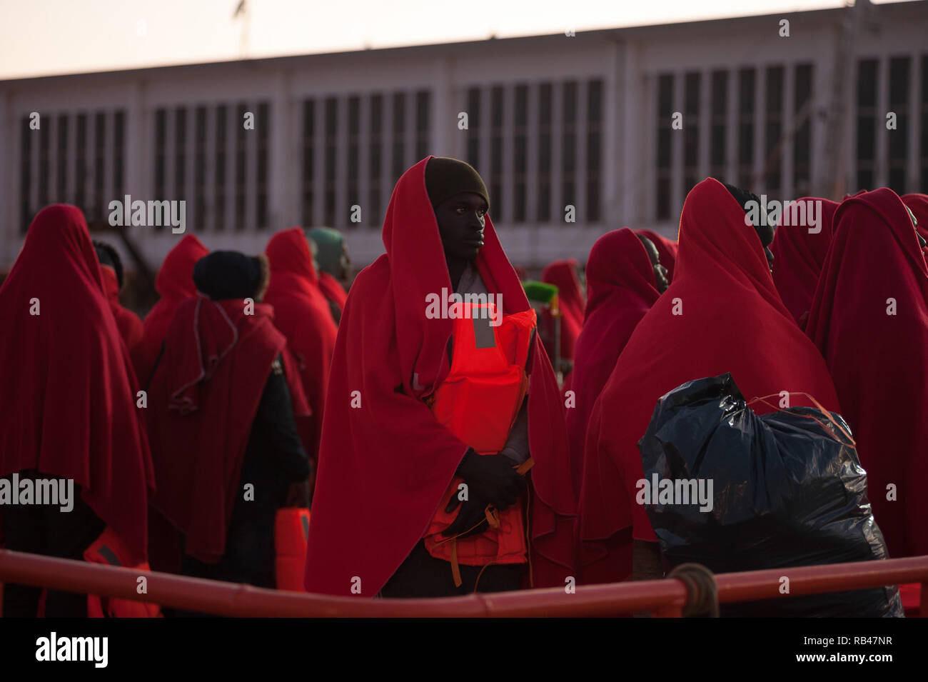 Malaga, Spain. 6h Jan 2019. Migrants seen waiting on a rescue vessel to disembark after their arrival at the Port of Malaga. Spain’s Maritime Rescue service rescued 185 migrants aboard dinghies at the Alboran Sea and brought them to Malaga harbor where they were assisted by the Spanish Red Cross. Credit: SOPA Images Limited/Alamy Live News Stock Photo