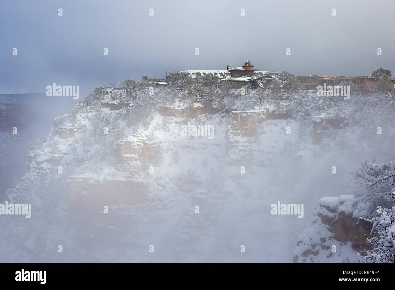Clouds and fog linger near the El Tovar hotel as a cold winter storm clears on the South Rim of the Grand Canyon in Grand Canyon National Park, Arizona, USA Stock Photo