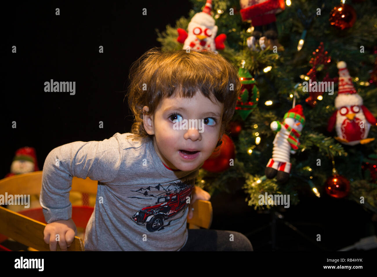 Cute baby boy with Christmas tree Stock Photo Alamy