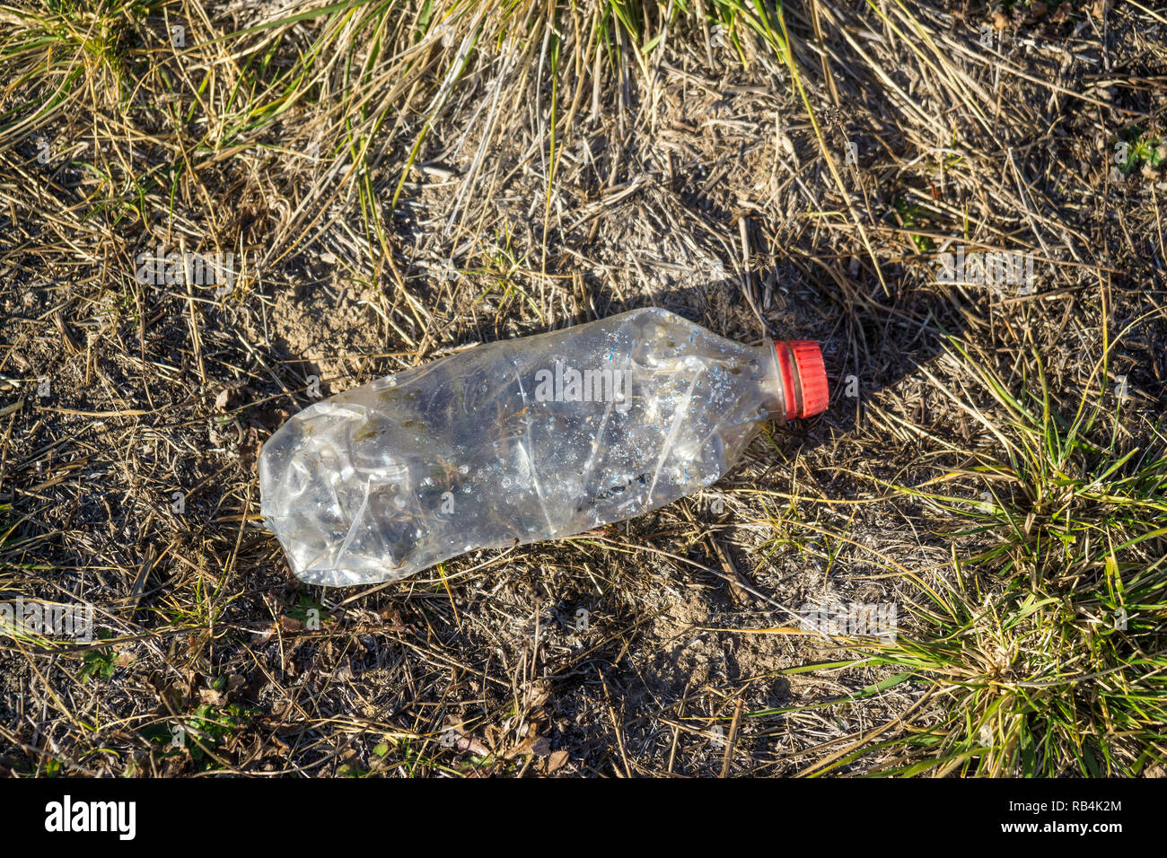 A plastic water bottle, causing an environmental problem after being discarded in a paddock in Australia Stock Photo