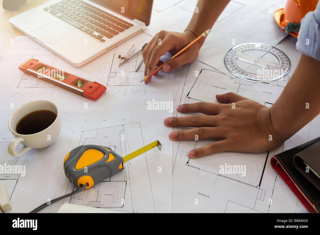 Architect or engineer working on blueprint in office, architectural concept Stock Photo