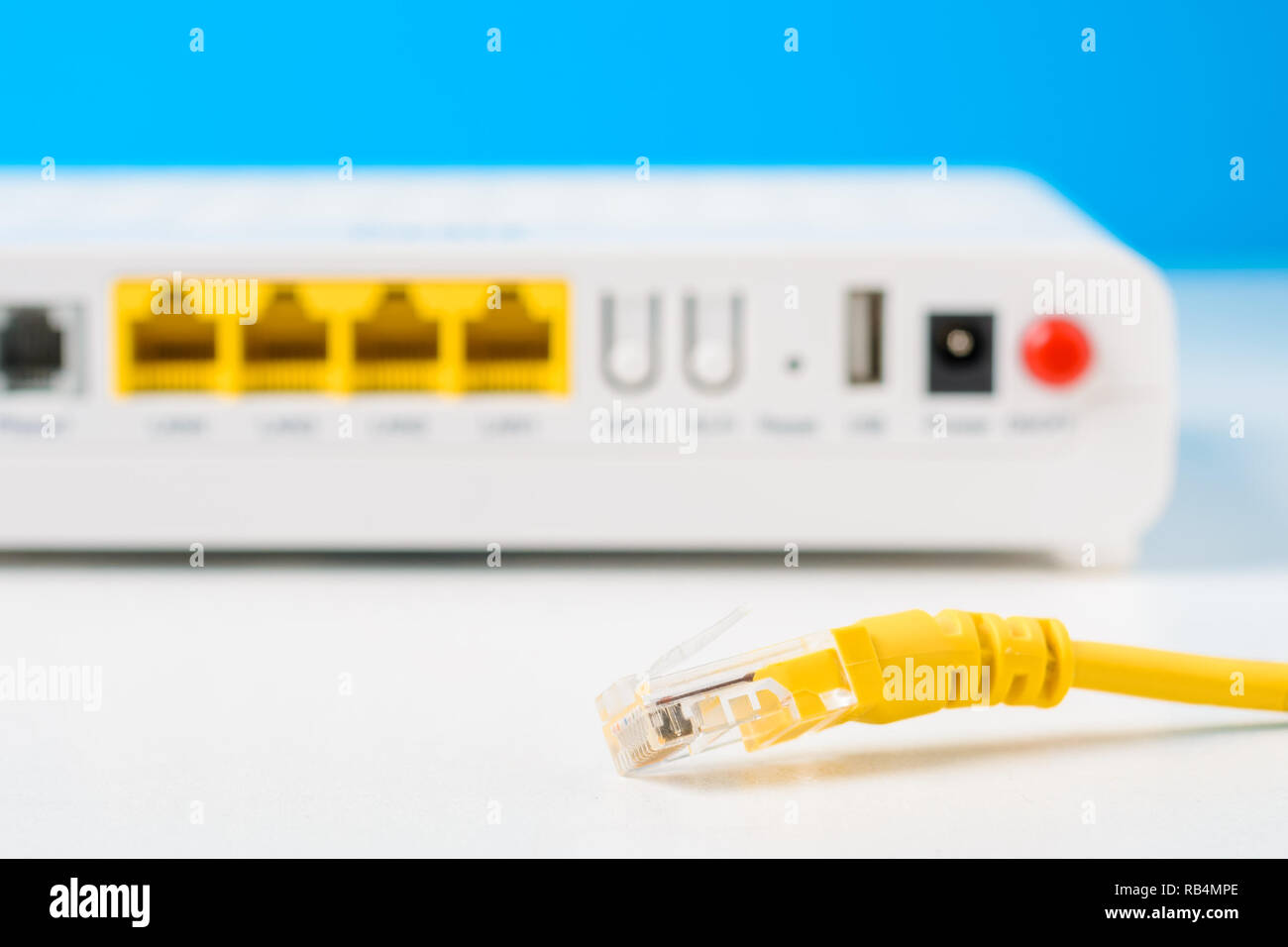 unplugged cable and router on blue background Stock