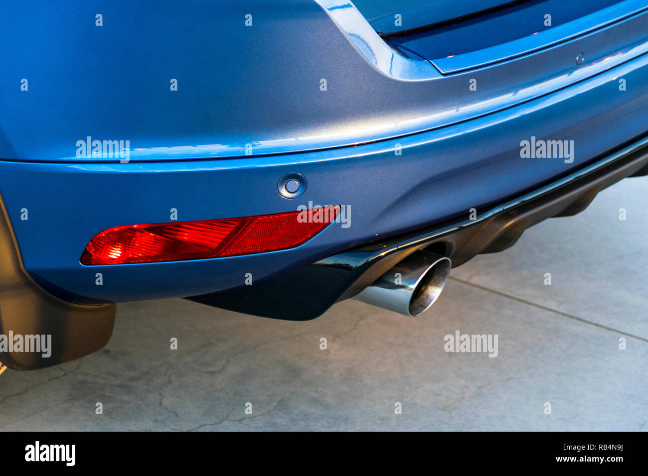 Rear bumper of a car with exhaust pipe, modern car exterior details Stock Photo