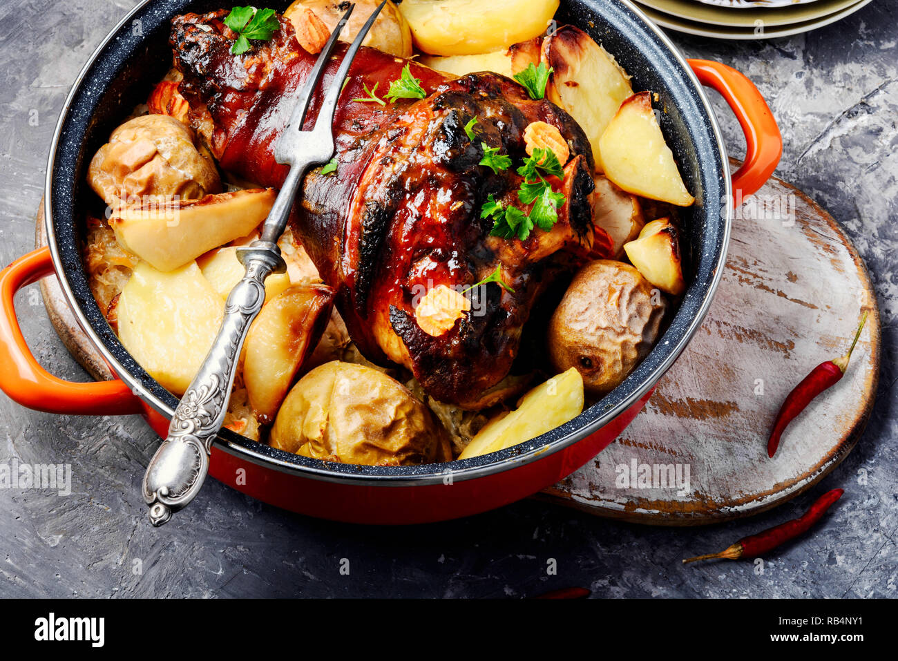 Pork knuckle on rustic table.Oktoberfest menu.Baked pork knuckle Stock