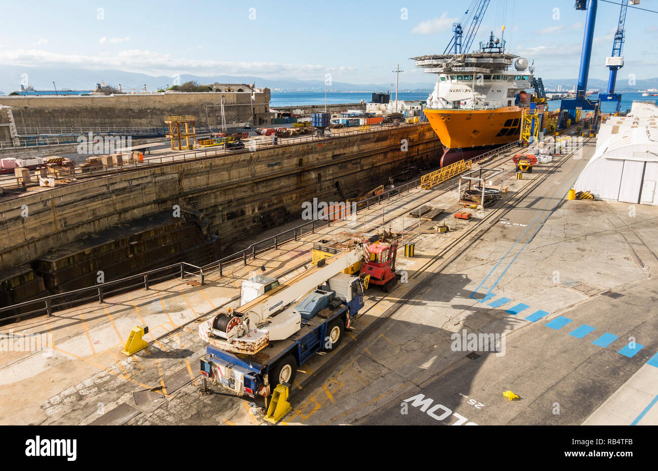 Gibraltar rock.Dry dock. SBM installer Vessel, support vessel being repaired in dry dock, British overseas territory of Gibraltar. Stock Photo