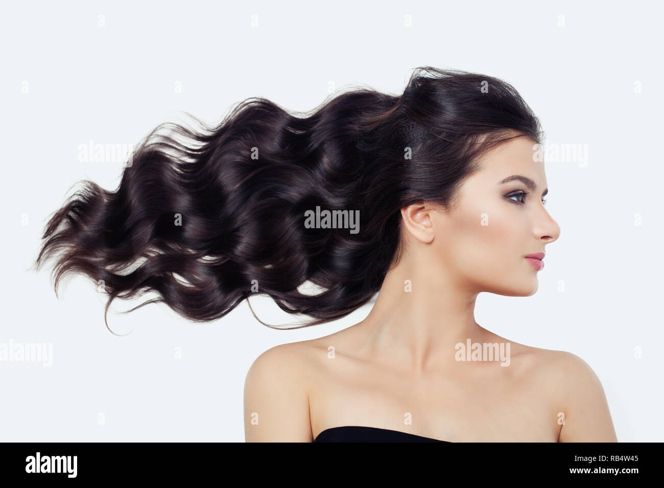 Young Cute Woman With Blowing Curly Hair On White Brunette Beauty