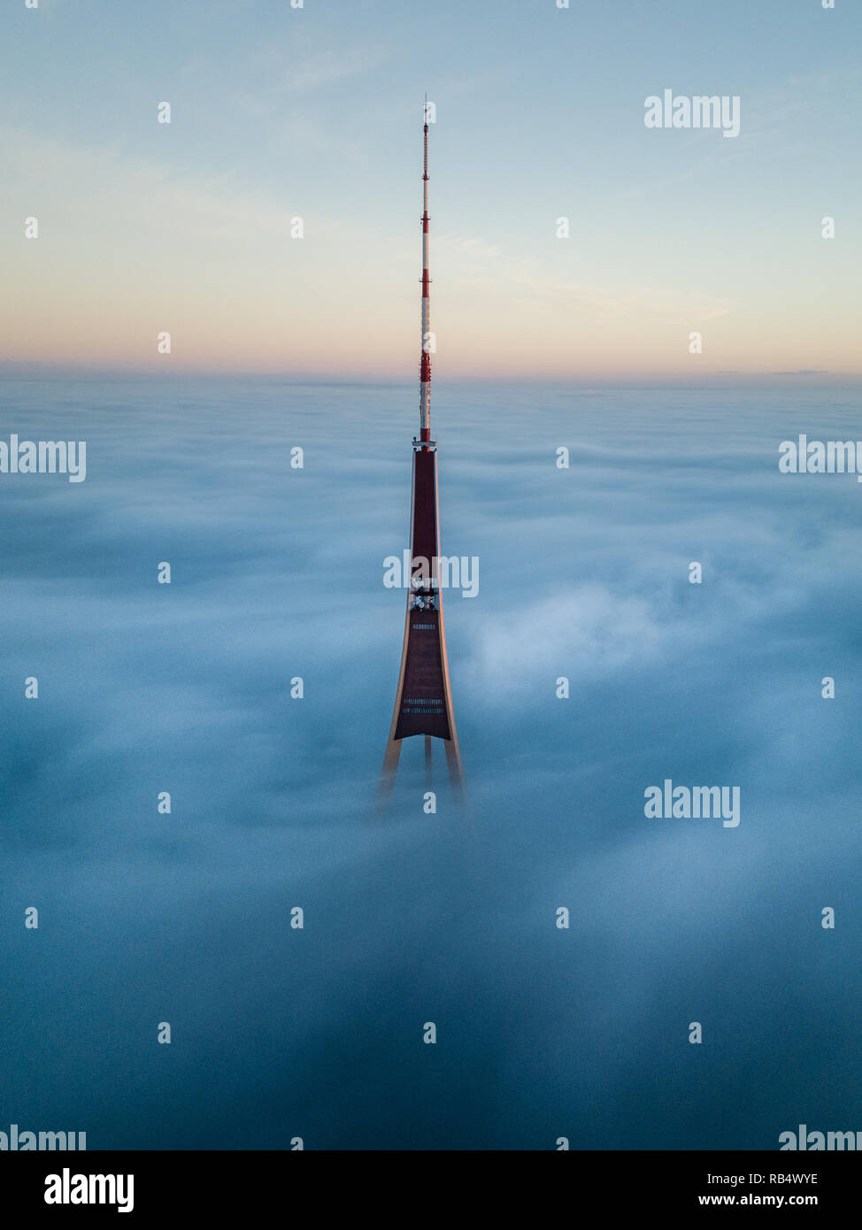 The Riga Radio and TV Tower in Riga, Latvia is the tallest tower in the  European Union. Tip sticking out of fog layer during beautiful sunrise  Stock Photo - Alamy