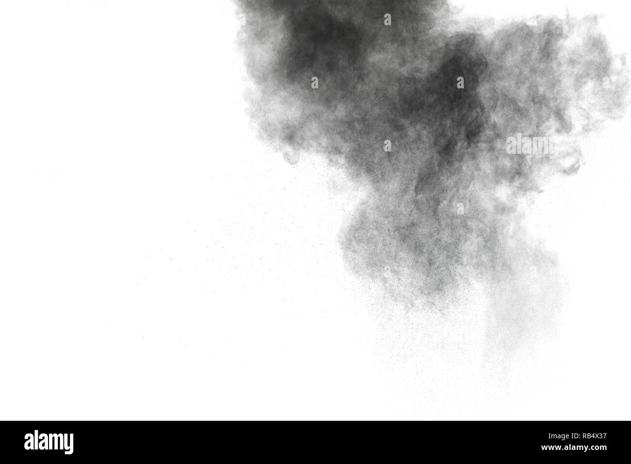 Black powder explosion against white background. Charcoal dust particle