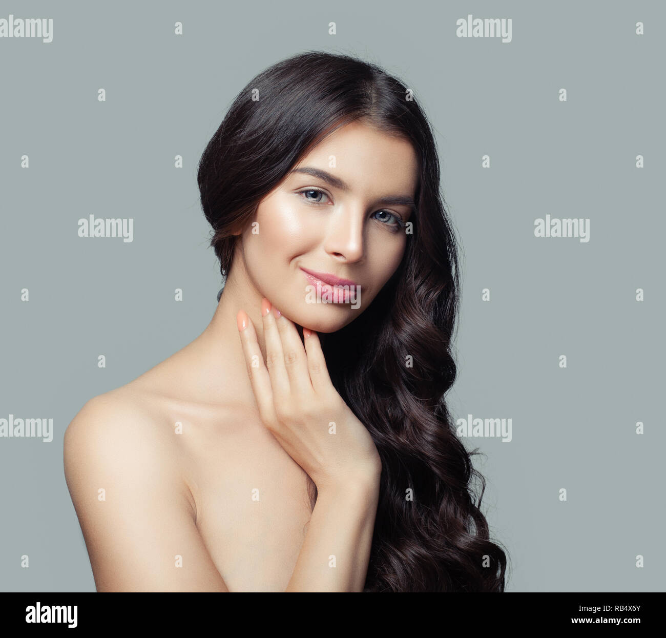 Smiling woman with long dark brown hair portrait Stock Photo