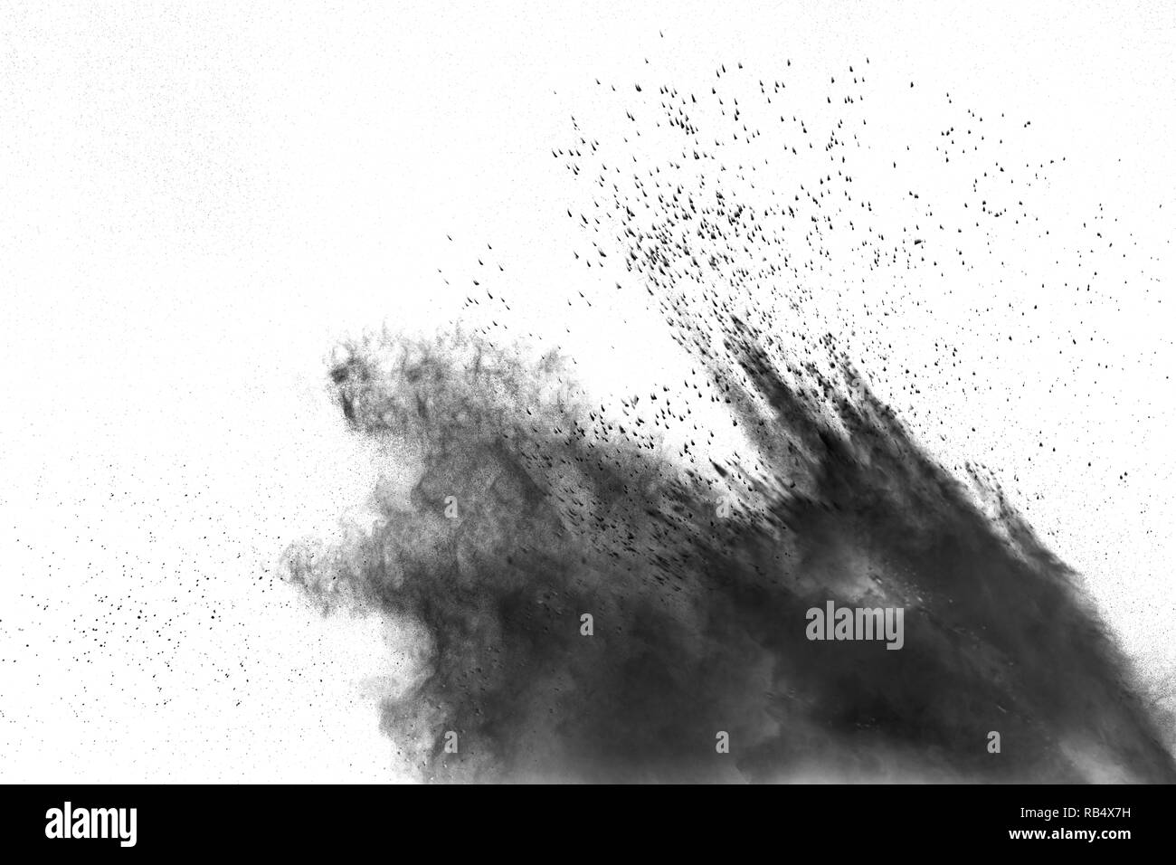 Black powder explosion against white background. Charcoal dust particle