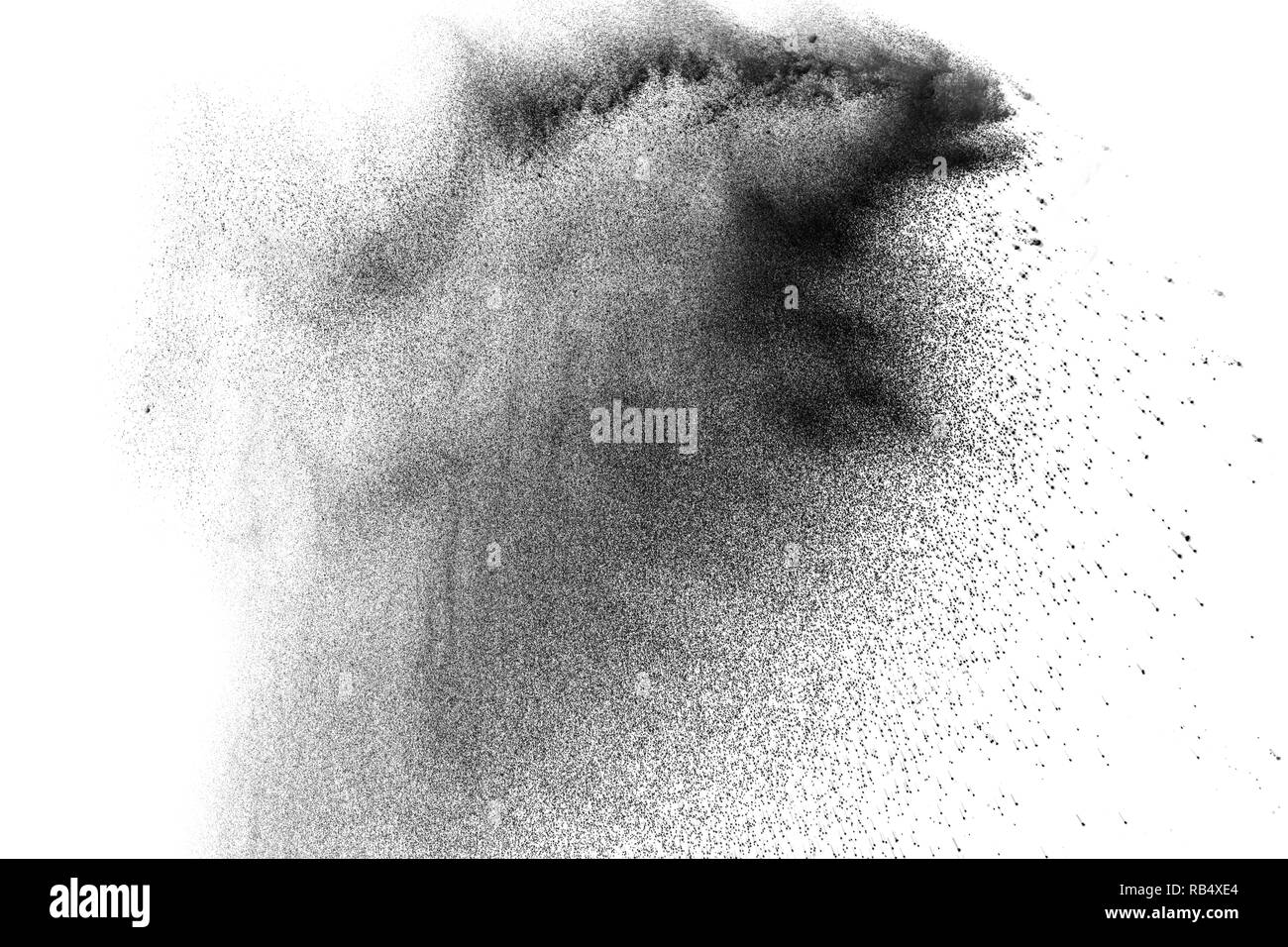 Black powder explosion against white background. Charcoal dust particle