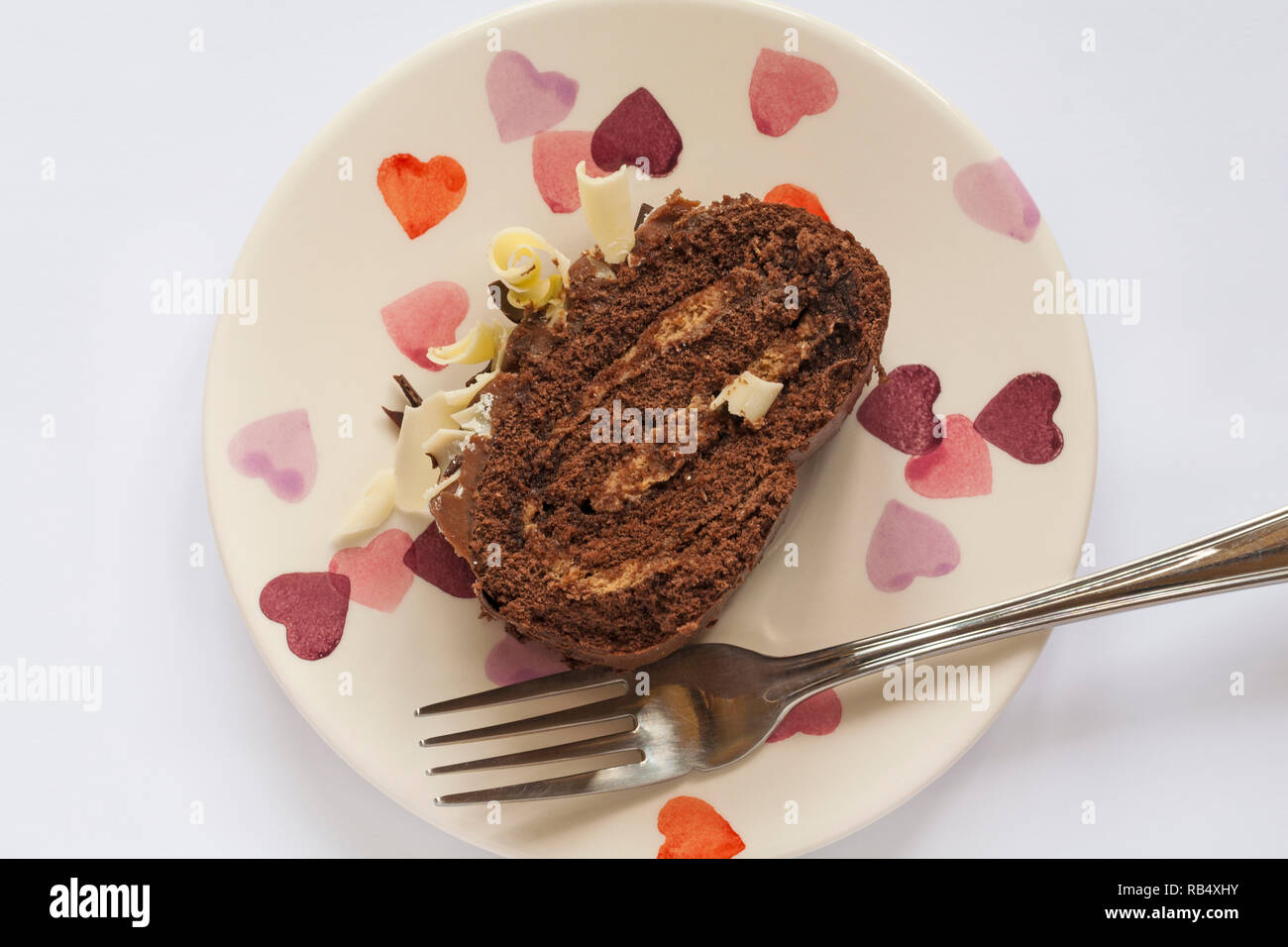 Slice of M&S Yuletide Log on plate with fork ready to eat - from above looking down on Stock Photo