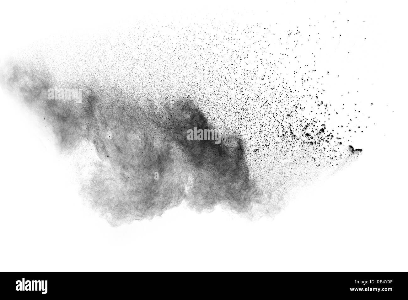 Black powder explosion against white background. Charcoal dust particle