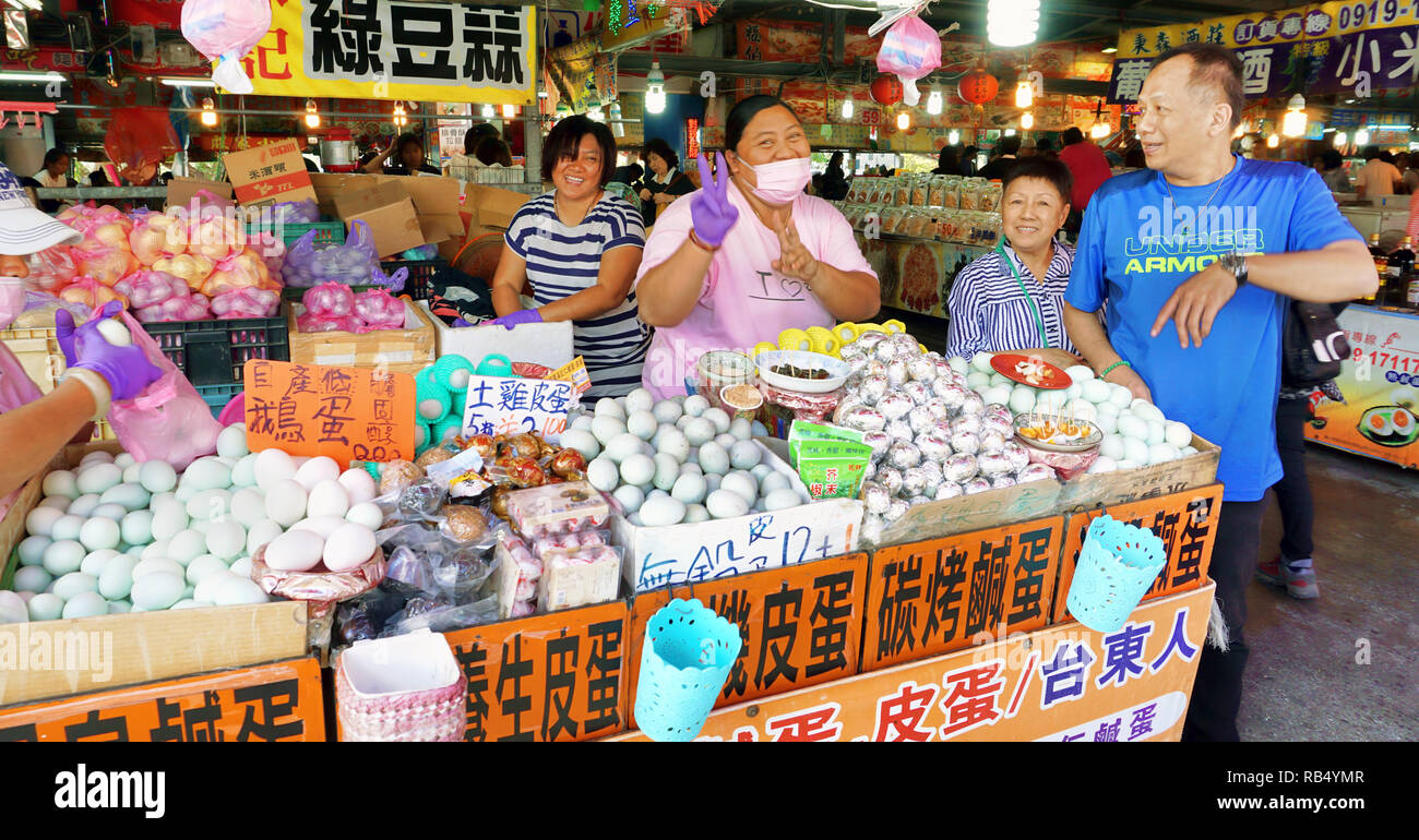 Hengchun,Taiwan - Dec.8, 2018 - Busy food court in Hengchun, Taiwan with busy egg lady selling fresh eggs. Stock Photo