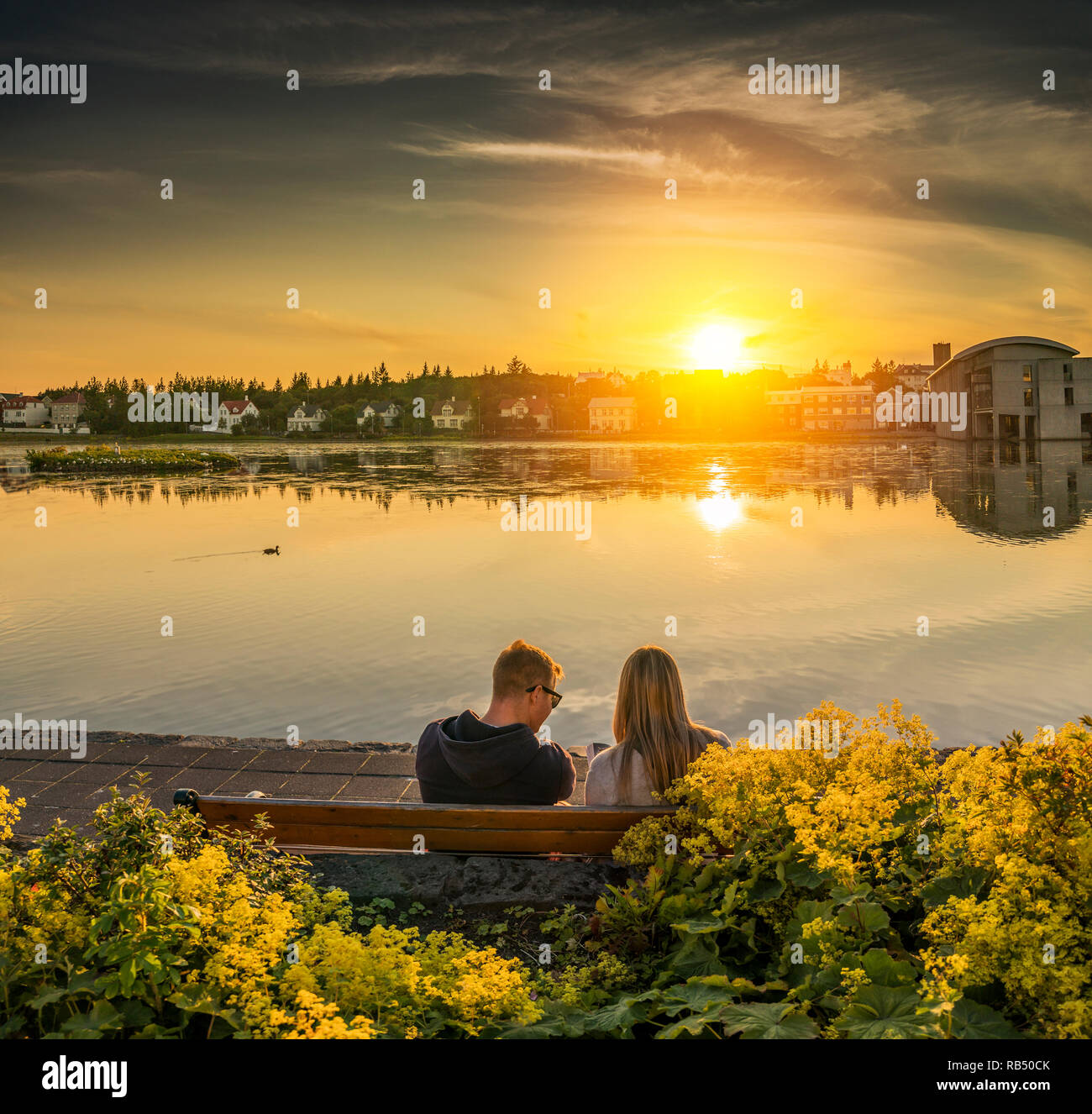 Couple watching the sunset, Summer Festival, Cultural Day, Reykjavik, Iceland Stock Photo