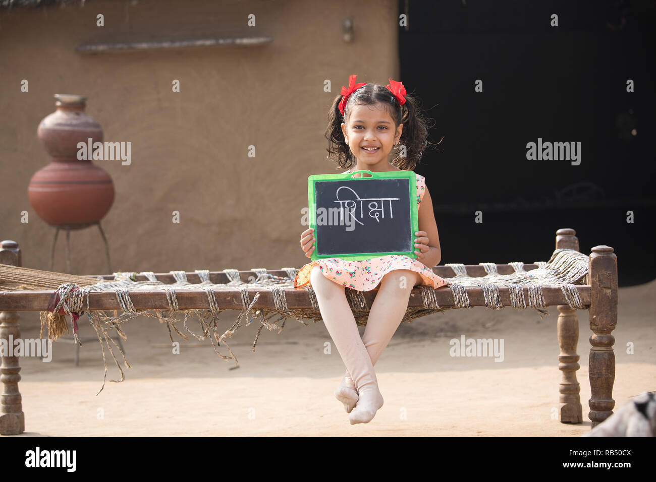 Indian girl sitting on house hi-res stock photography and images - Alamy