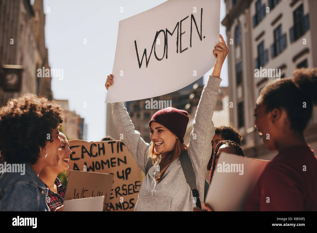 Group of multiracial women protesting outdoors with placards. Females gathering on road for demonstrations for women empowerment. Stock Photo