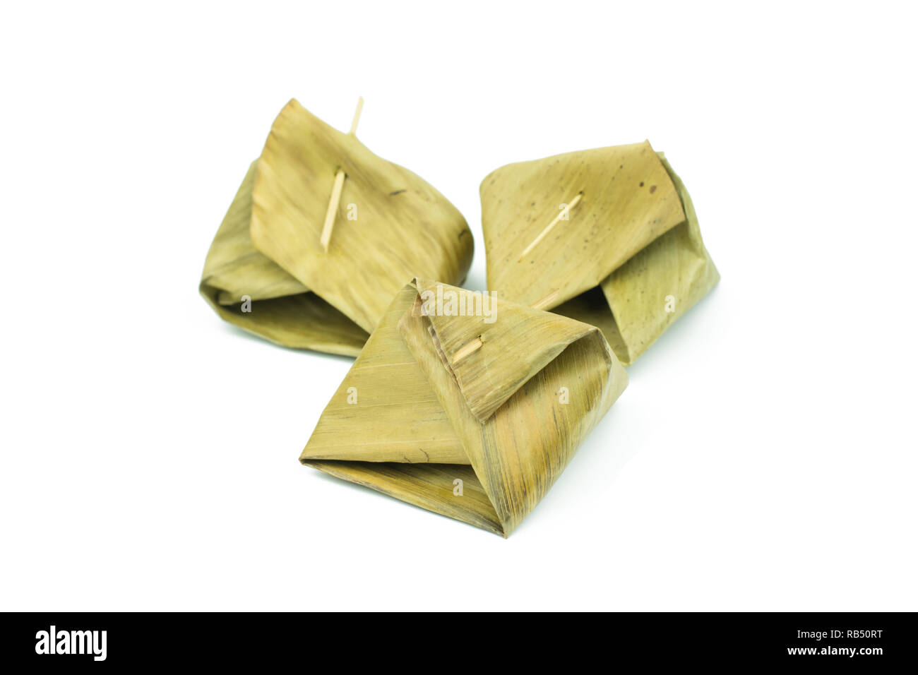 Thai dessert wrapped in banana leaf isolated on white background Stock