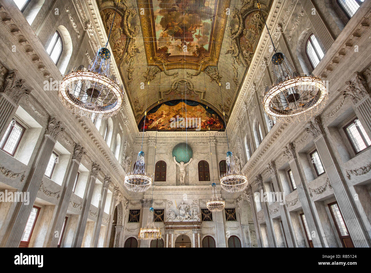 The Netherlands, Amsterdam, Dam Square. Royal Palace. Interior. Burgerzaal or Citizens' Hall. Statue of Atlas carrying the globe. Stock Photo
