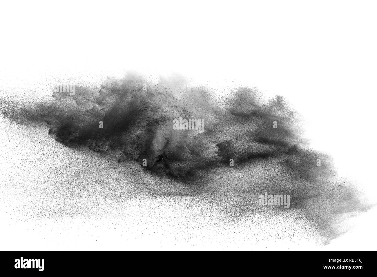 Black powder explosion against white background. Charcoal dust particle