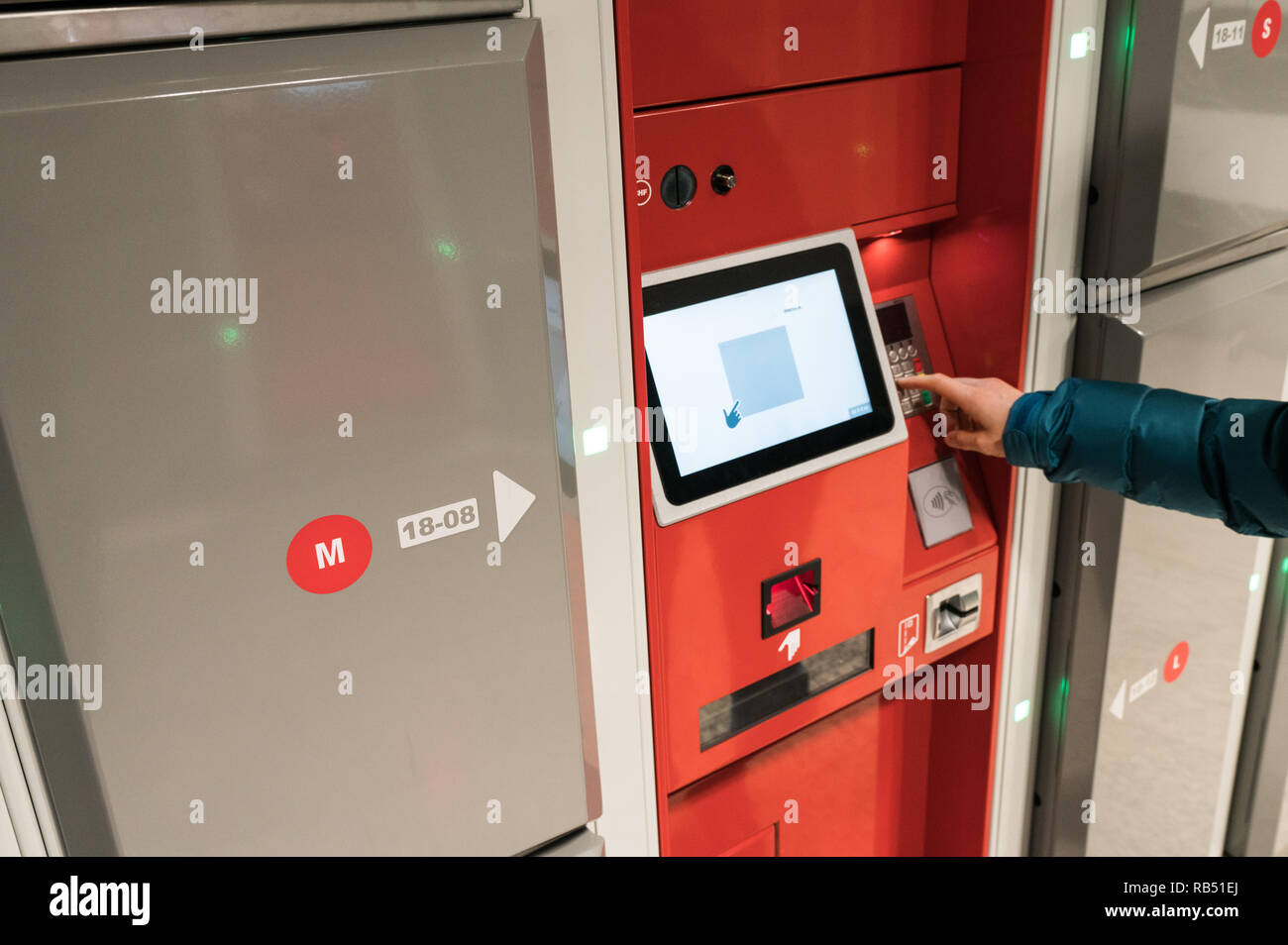 female tourist uses the luggage storage facility at the train station