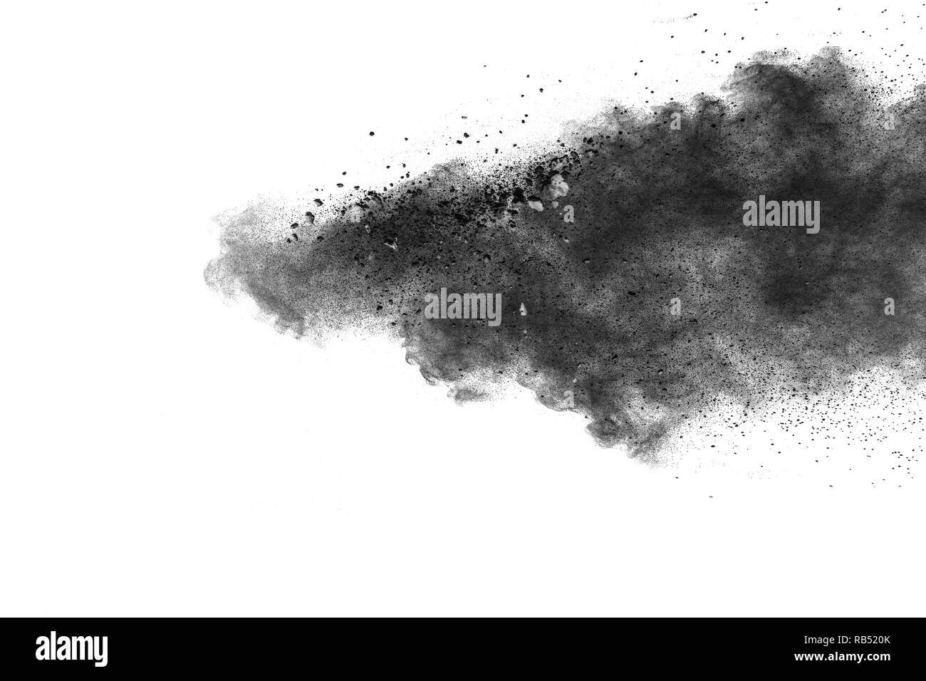 Black powder explosion against white background. Charcoal dust particle exhaie in the air. Stock Photo