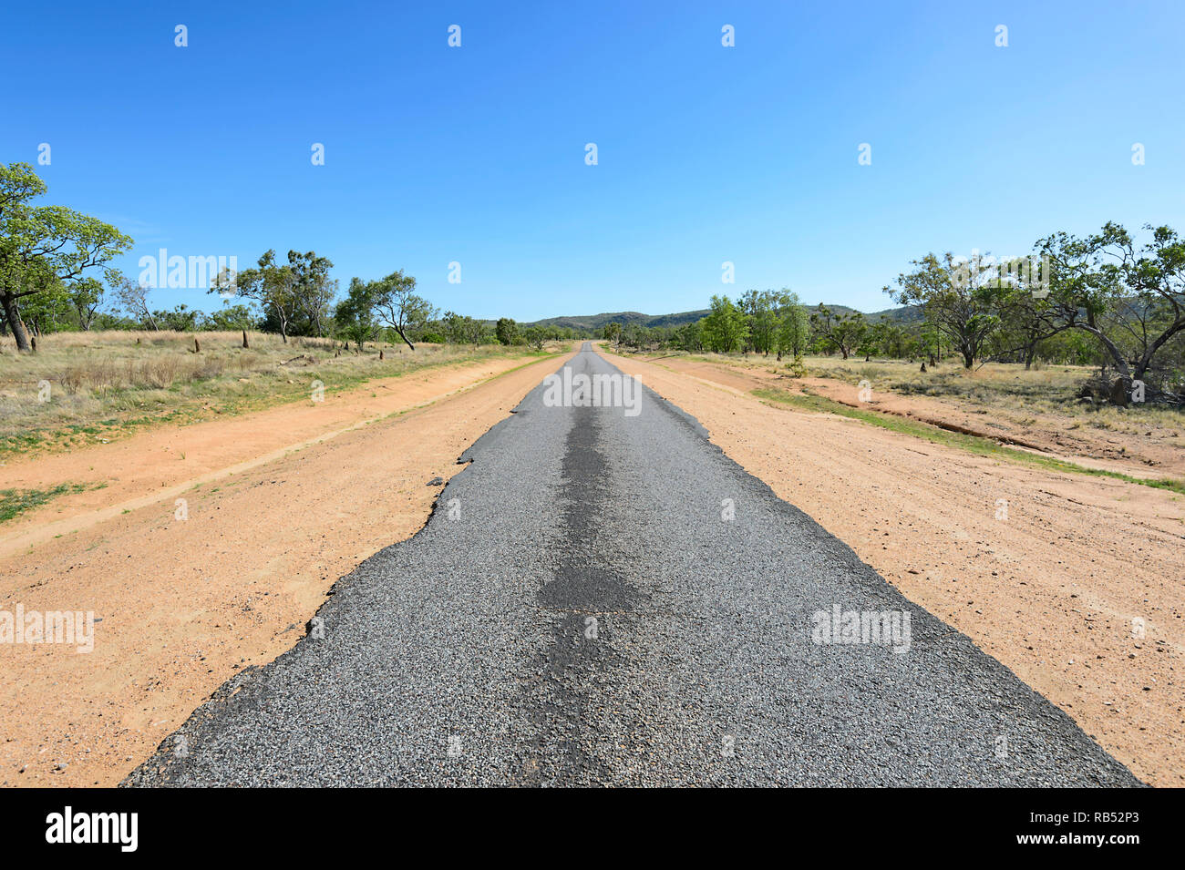 Part of the Savannah Way is a deserted narrow straight ribbon road, Queensland, QLD, Australia Stock Photo