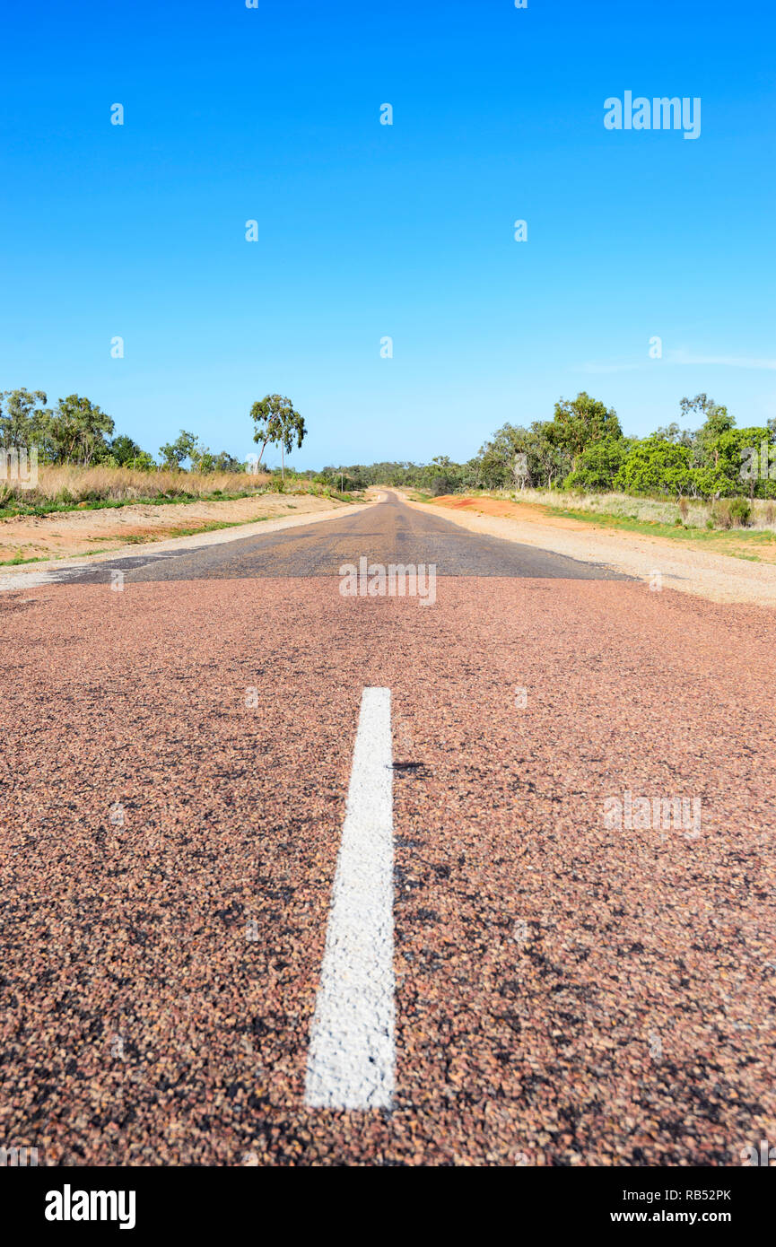 Middle of the road on the Savannah Way at the beginning of a narrow ribbon road stretch, Queensland, QLD, Australia Stock Photo