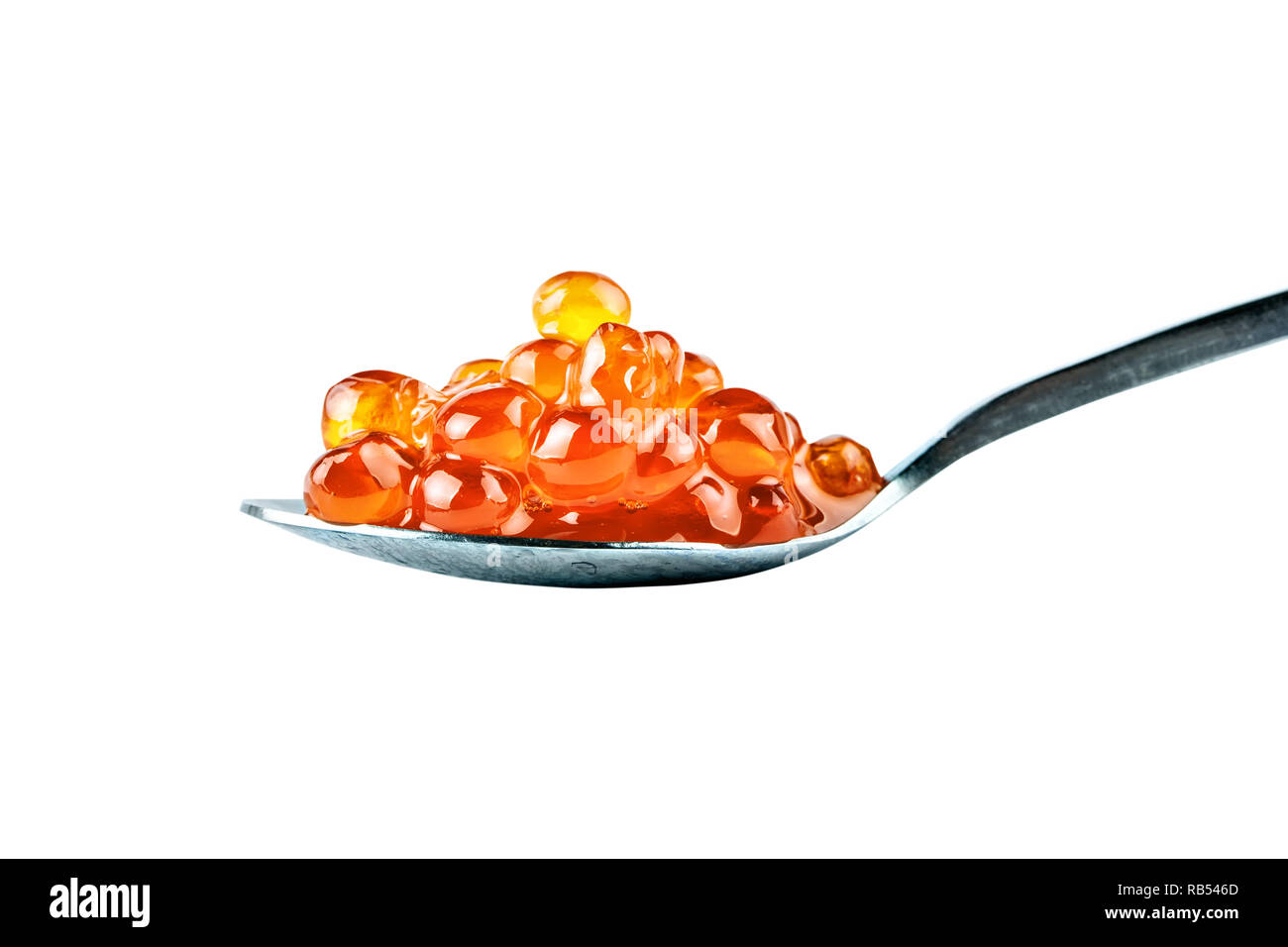 Red caviar in the silver spoon. Isolated object on white background. Close up. Stock Photo