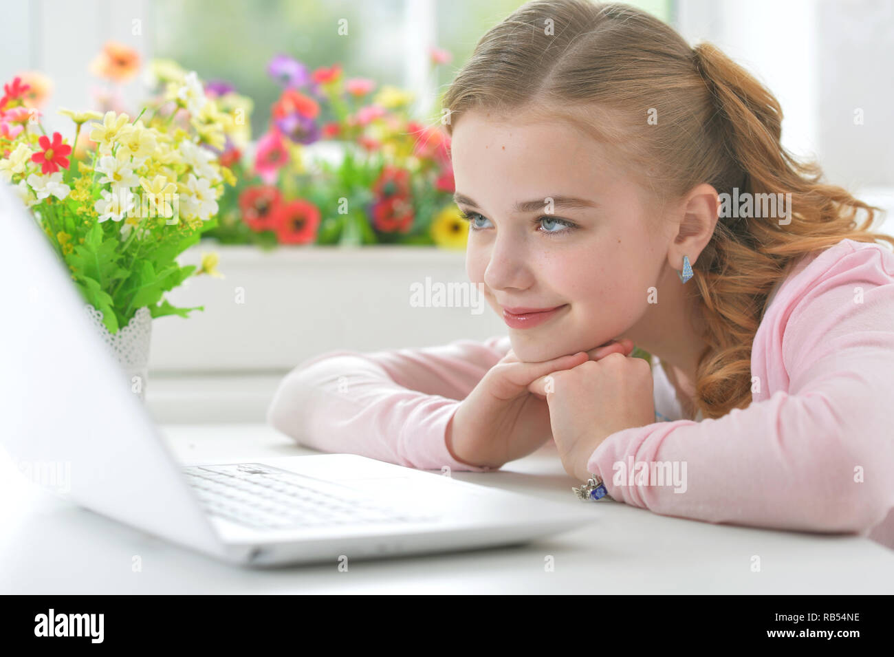Portrait of little girl with modern laptop Stock Photo - Alamy