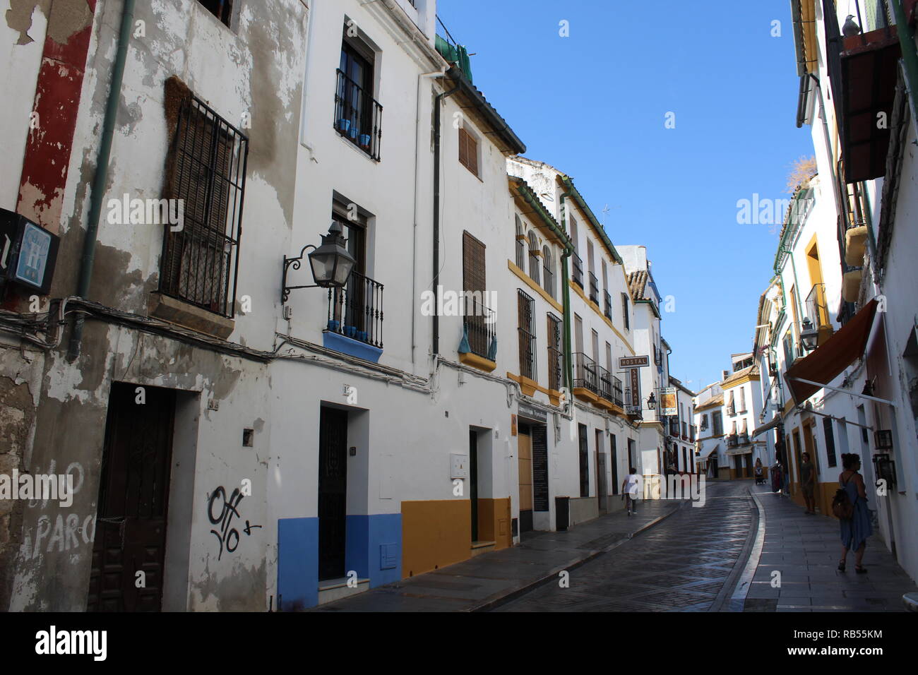 A classic Spanish styled street in Cordoba, Andalusia, Spain, presenting white buildings and Spanish architecture Stock Photo