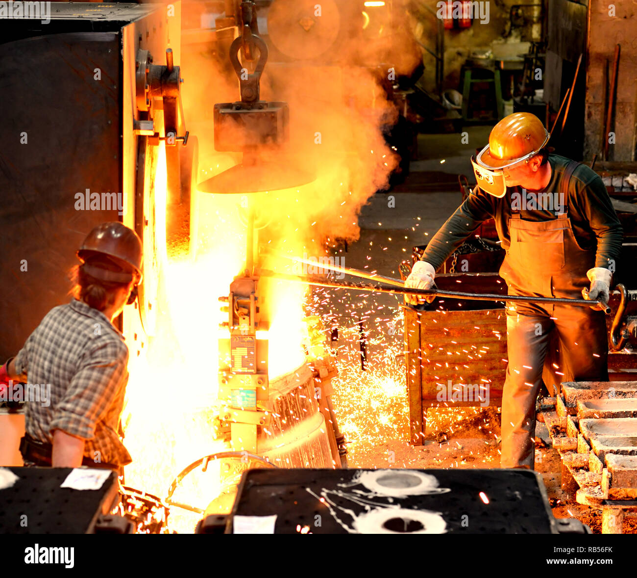 workers-in-a-foundry-casting-a-metal-workpiece-safety-at-work-and