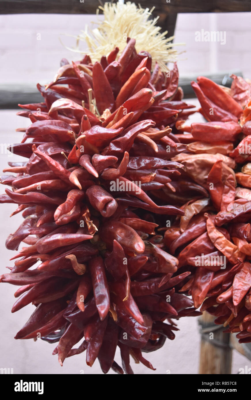 Hanging and drying red hot chili peppers Stock Photo - Alamy