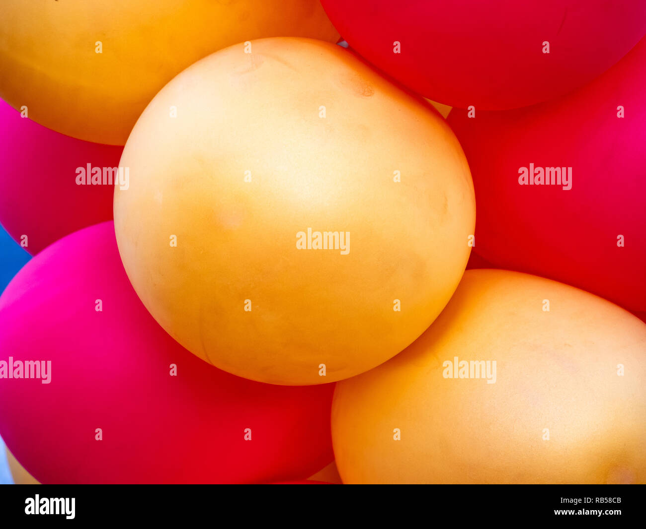 Detail of a row of red and yellow balloons with a side view. Horizontal ...