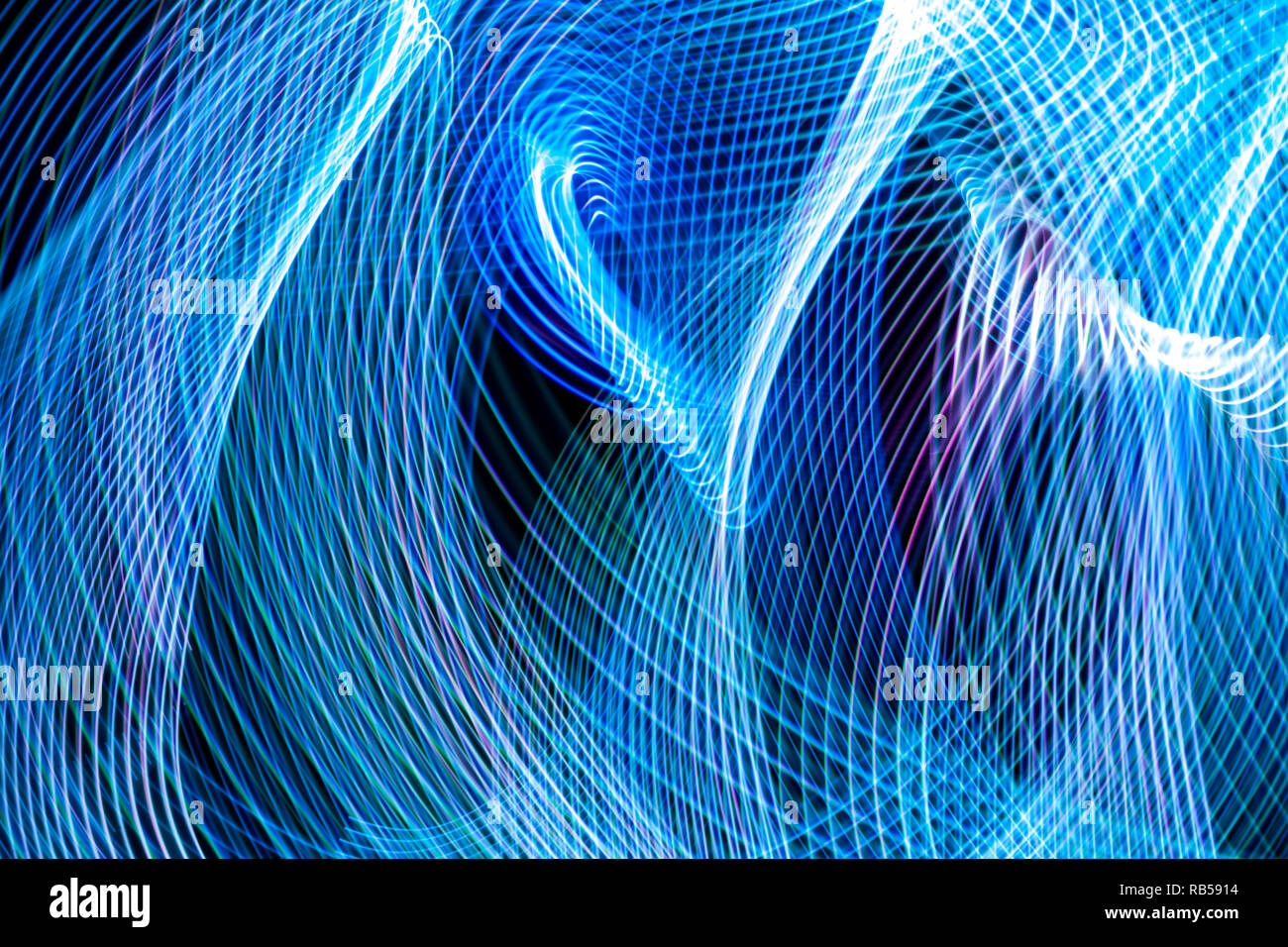 Abstract blue and purple neon glowing crossing lines pattern. Dark ...
