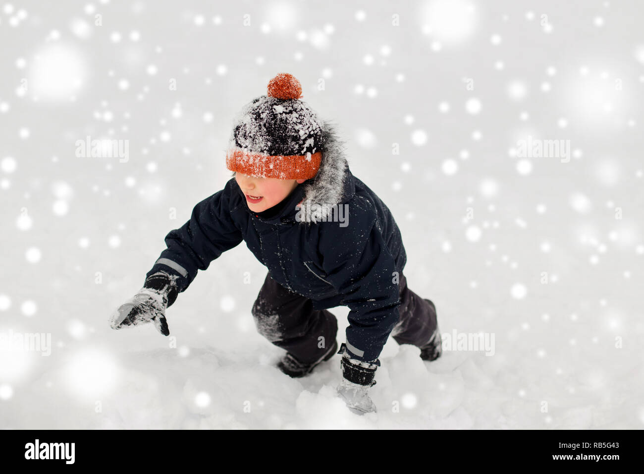 happy little boy in winter clothes outdoors Stock Photo Alamy