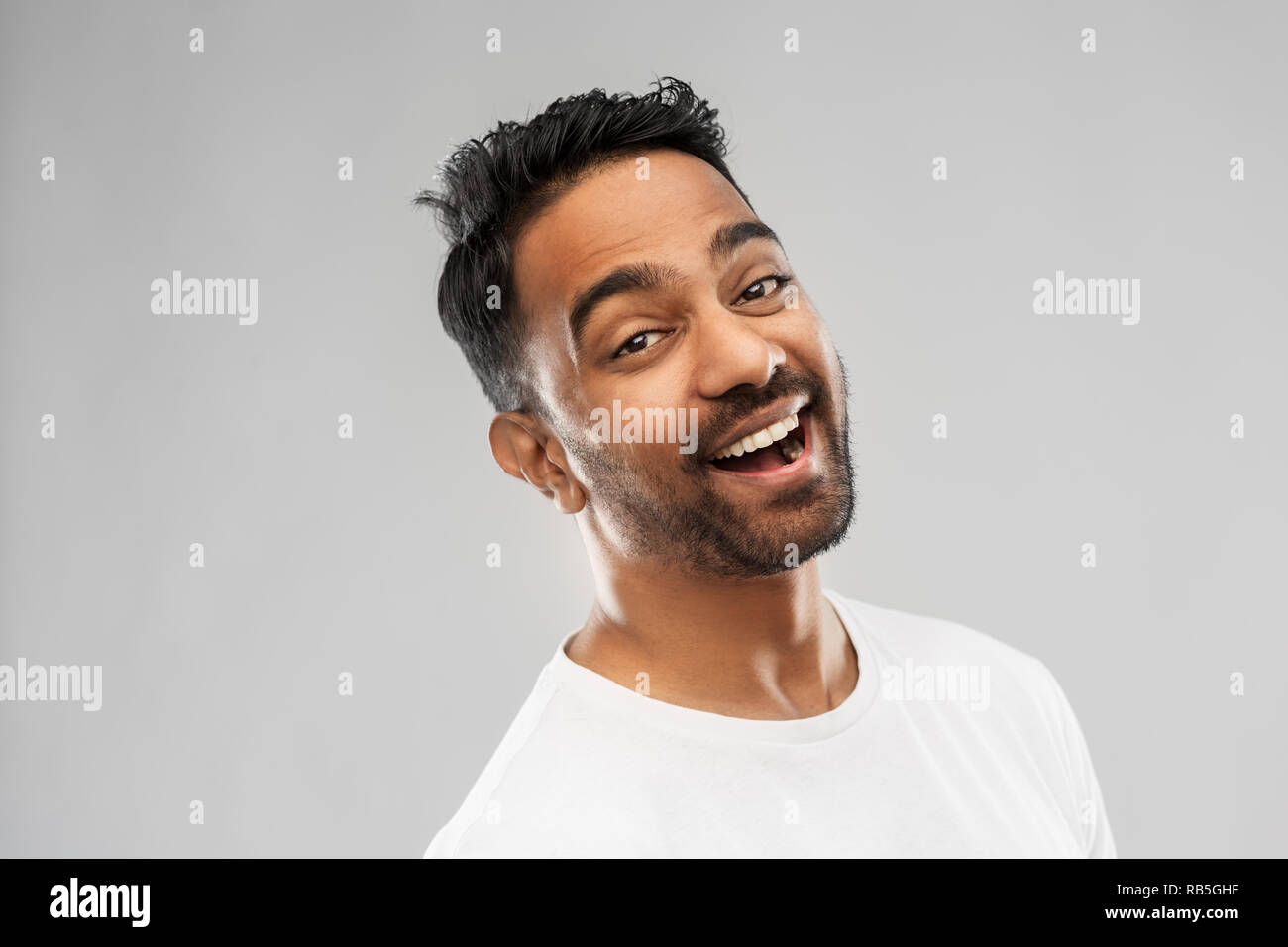 young laughing indian man over gray background Stock Photo - Alamy