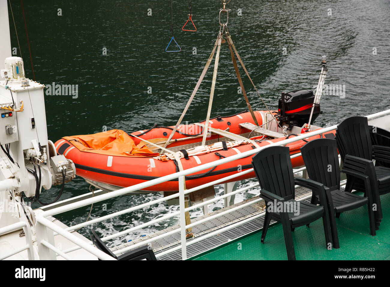 Rubber dinghy with powerful outboard engine on the ship. Stock Photo