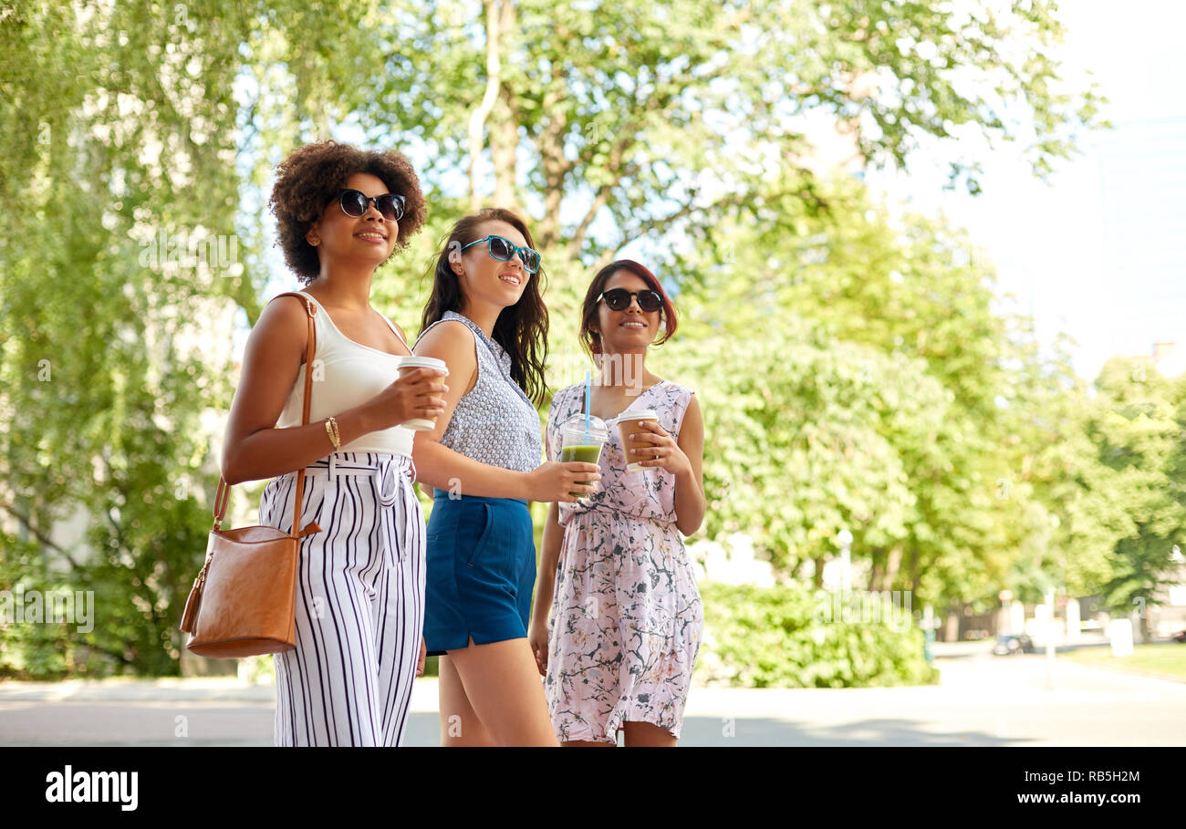happy women or friends with drinks at summer park Stock Photo