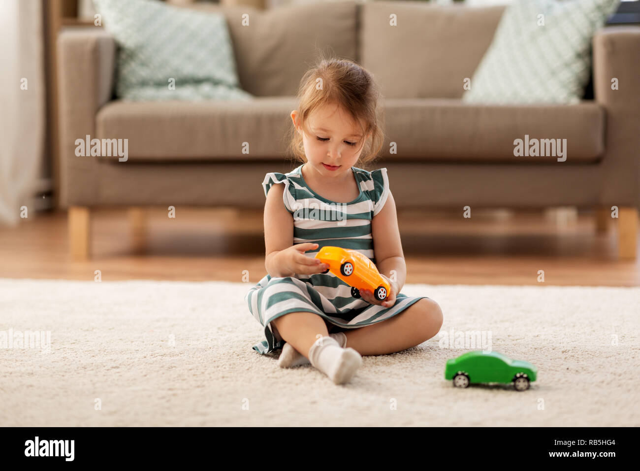 happy baby girl playing with toy car at home Stock Photo - Alamy