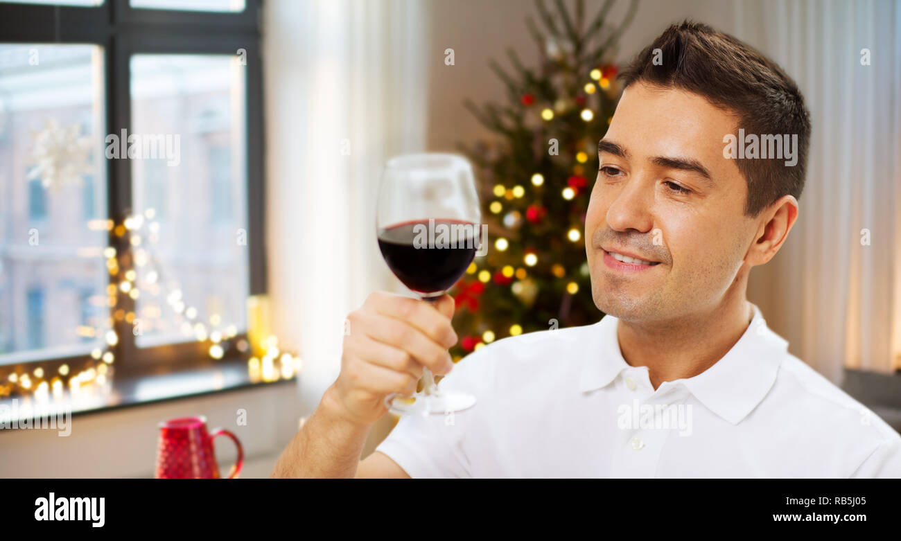 happy man drinking red wine at home on christmas Stock Photo - Alamy