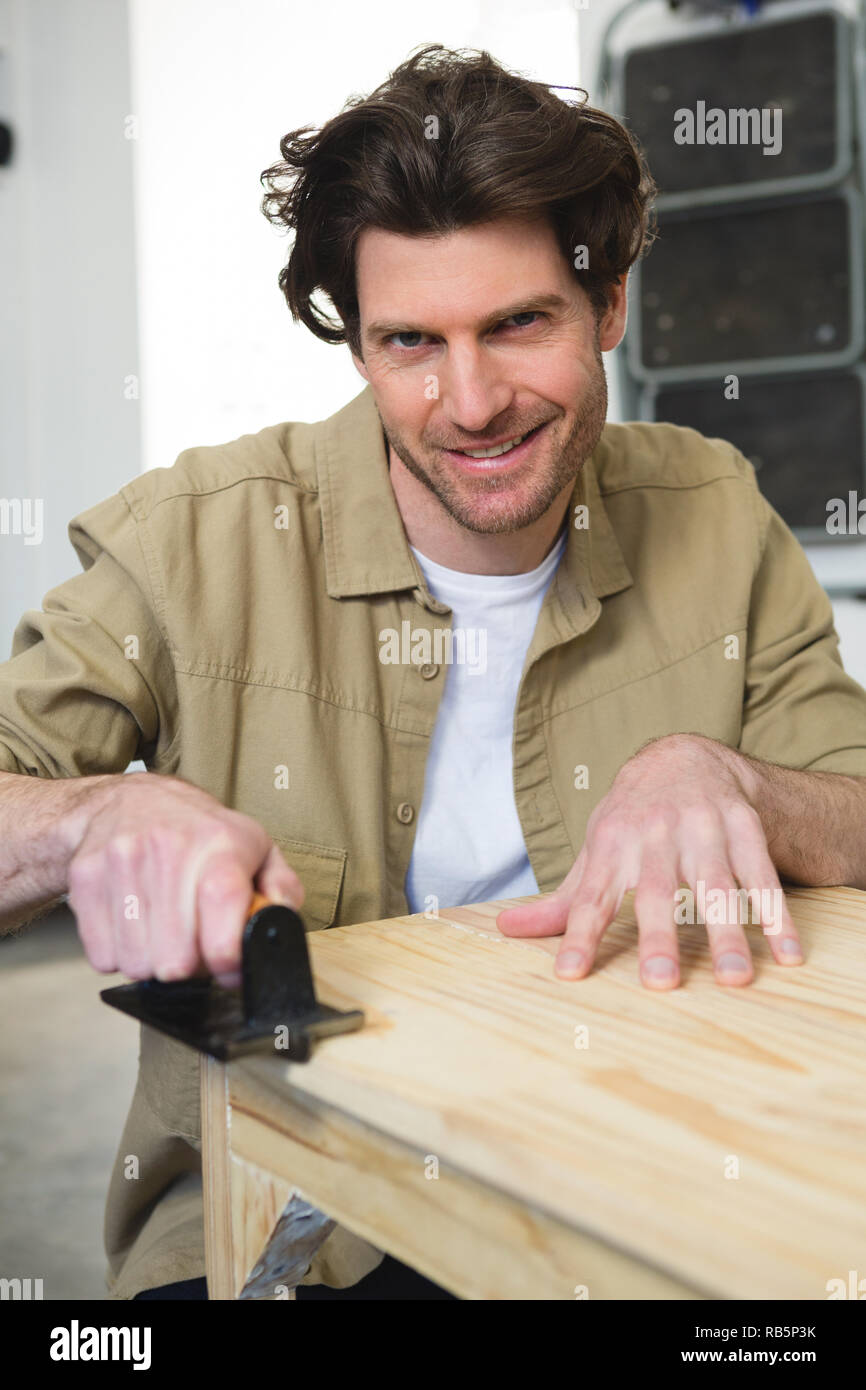 Male carpenter working on wood Stock Photo