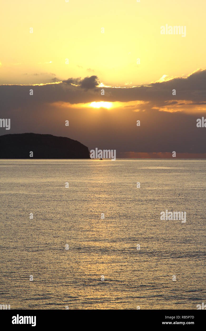 Sun rising above the Mediterranean sea . This image was taken from the Island of Ibiza. Ideal for a moody book cover. Stock Photo