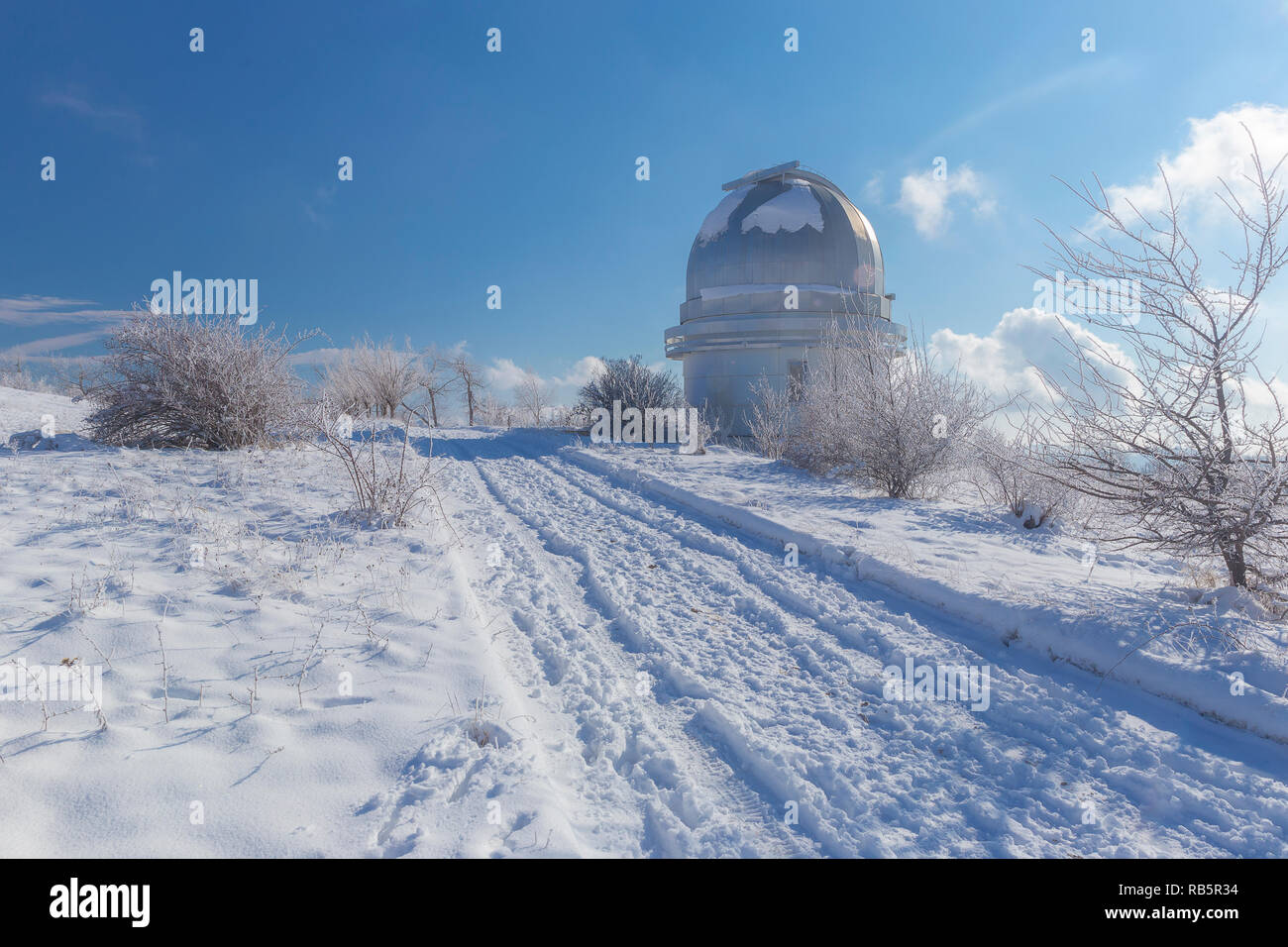 Small dome of the telescope at the Shemakha Observatory in winter Stock Photo